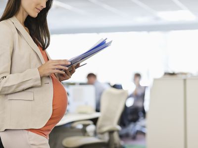 A pregnant woman in an office