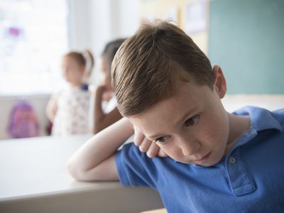 Sad student leaning on desk