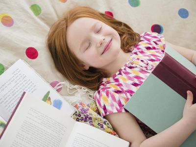 girl smiling with books, loves reading