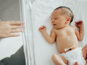 baby in hospital with clamp on umbilical cord