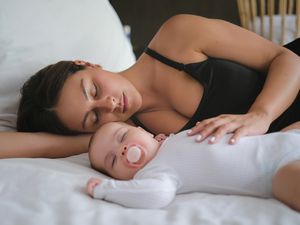 Tired mother and baby