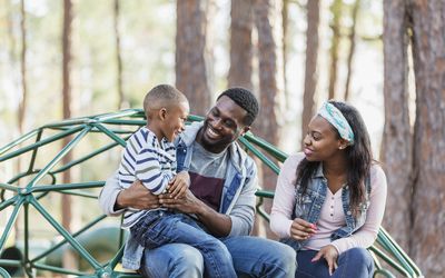 African-American family with boy on playground