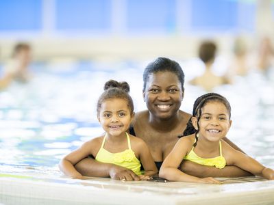 Family-friendly gyms - mom and daughters at pool