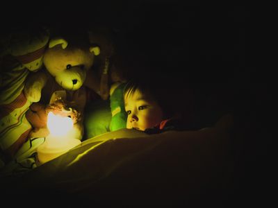 Child with night light