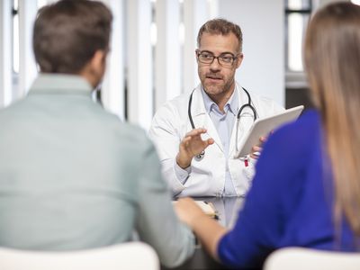 Doctor speaking to couple