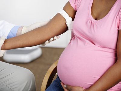 A close-up of a pregnant woman's arm at a medical office