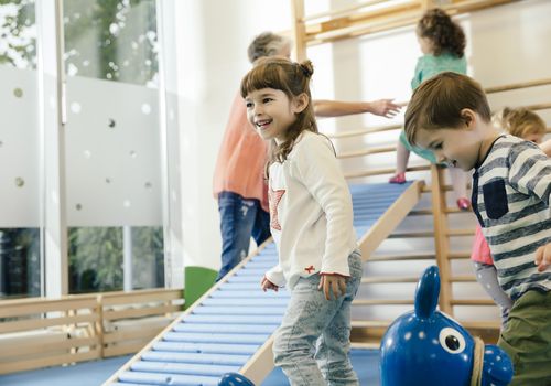 Happy children in gym room in kindergarten