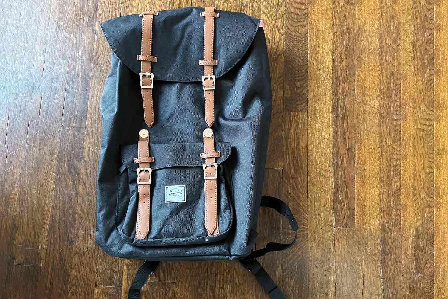 The Herschel Little America Backpack on the floor