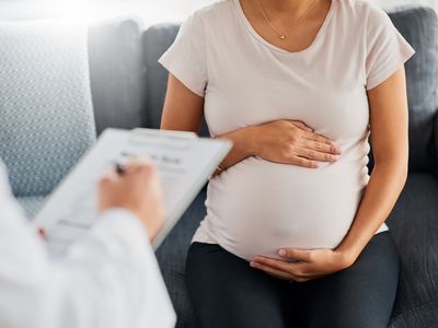 Shot of a pregnant young woman at appointment with doctor
