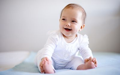 smiling baby girl in white