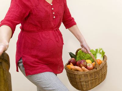Pregnant woman carrying groceries