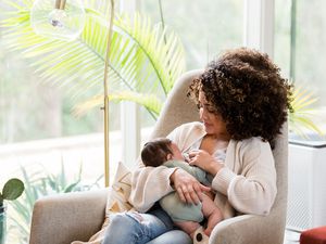 woman breastfeeding a newborn baby