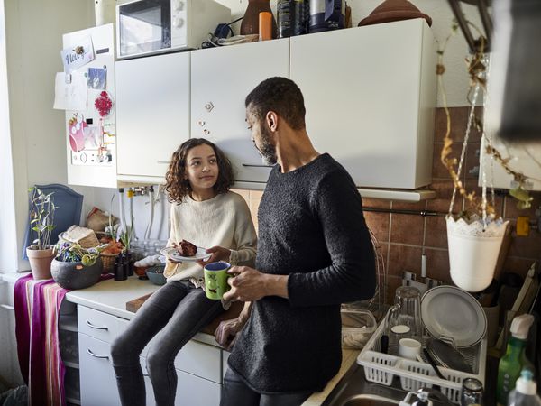 father and daughter talking in kitchen