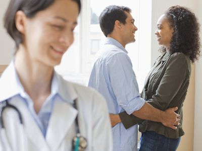 Doctor with embracing couple