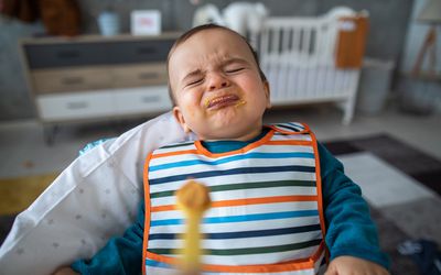 Angry toddler spitting up food