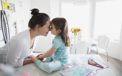 Affectionate mother and daughter rubbing noses in pajamas＂width=