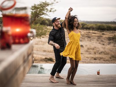 Man and woman dancing by the water