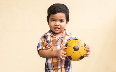 Toddler boy holding a ball