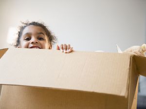 Young girl in a moving box.