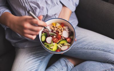 Teen eating a bowl of vegetables