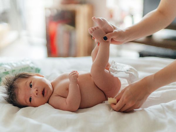 Asian baby getting diaper changed.