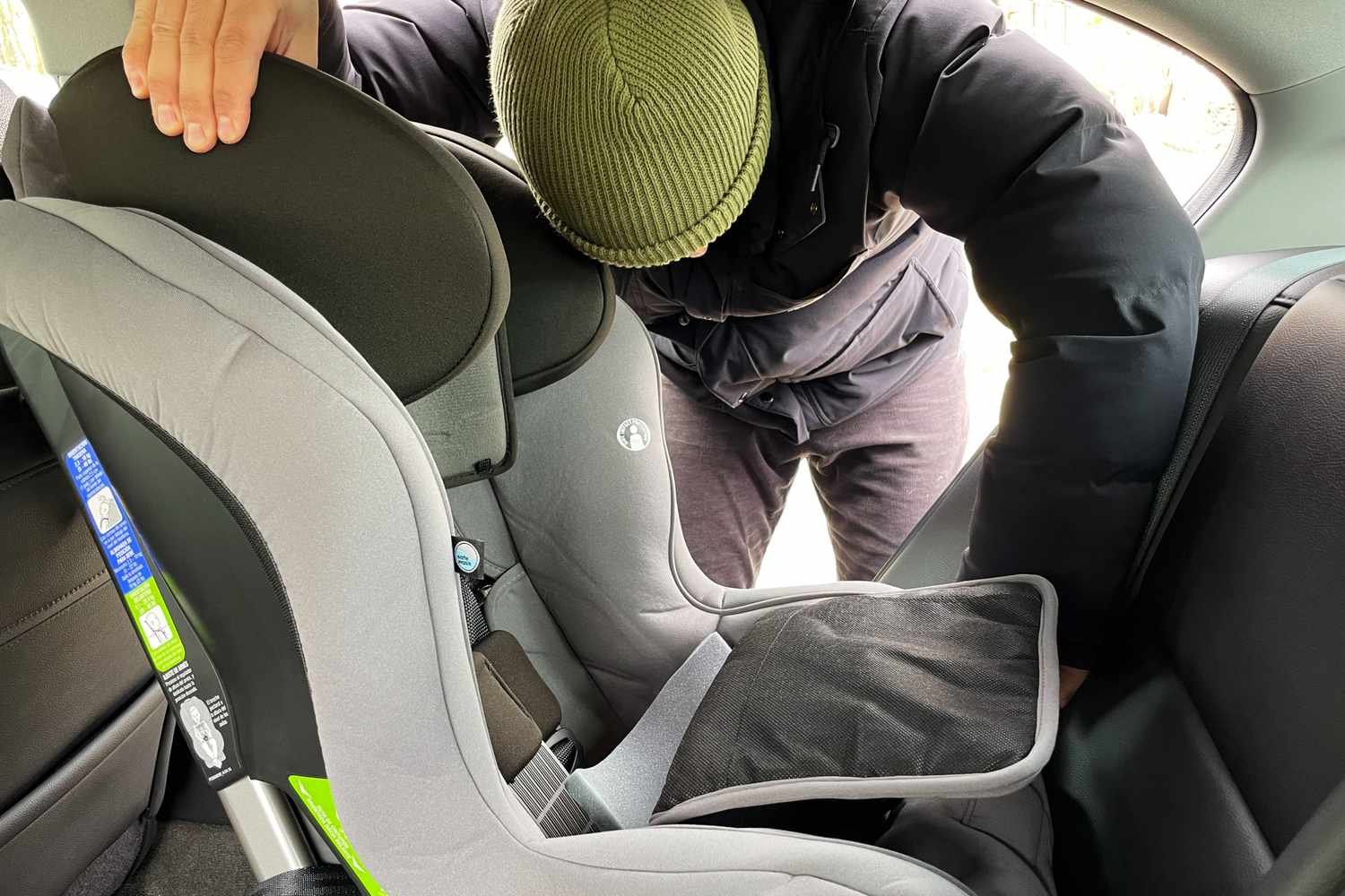 Person installing the Britax Emblem 3-Stage Convertible Car Seat in their car