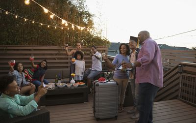 family celebrating graduation outside on deck