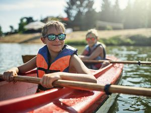 Kids kayaking on a lake