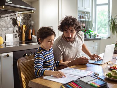 Father helping his son with schoolwork