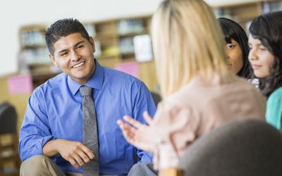 Hispanic counselor discussing something during group therapy session