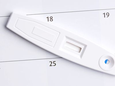 pregnancy test sitting on a calendar