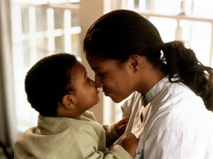 Mother rubbing noses with her son