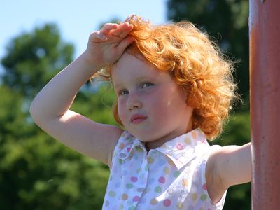 Young girl at the park may have heat stroke