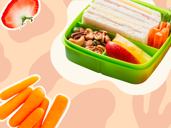 photo illustration of bento box with sandwich, apple, and other foods in it