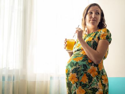 Pregnant woman with drinking glass