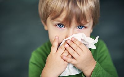 boy wiping nose