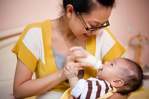 母亲用奶瓶喂婴儿