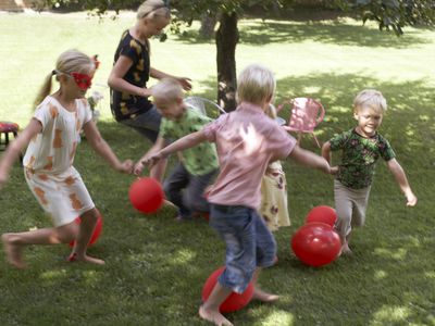 Kids playing a game with balloons