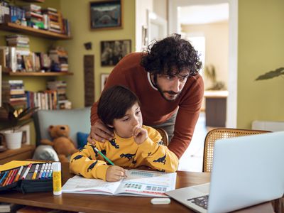 Father helping his son with schoolwork