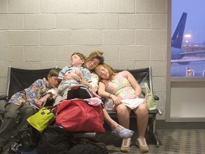 Family sleeping at airport