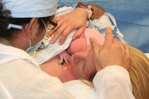 A mother holding her baby after a c-section