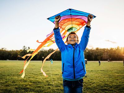 Young Boy Enjoying Learning How To Fly Kite