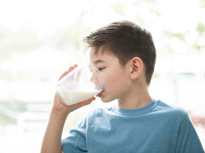 Young boy drinking milk