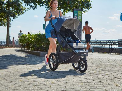 The author testing the UPPAbaby Ridge jogging stroller on a sidewalk in New York City