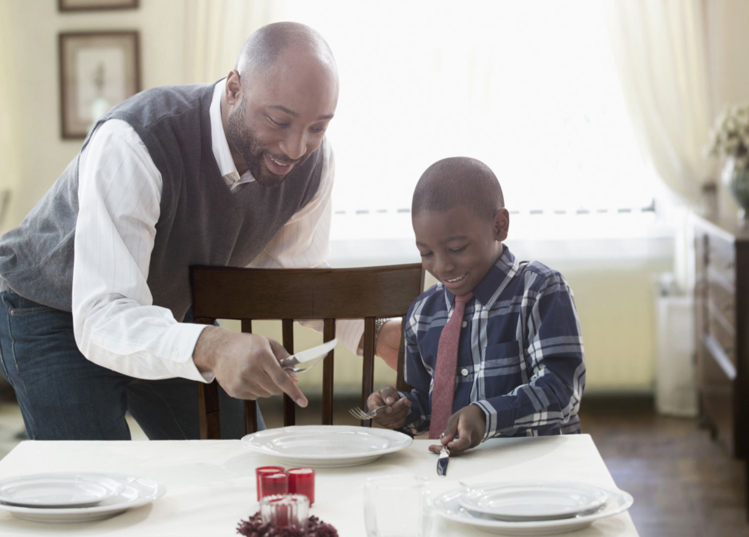 Father and son setting holiday table