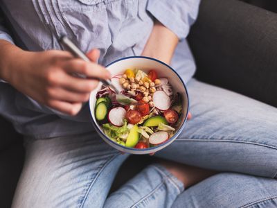 Teen eating a bowl of vegetables