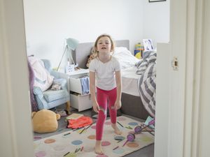 Young girl having tantrum in bedroom