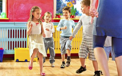 Children dancing together at a preschool