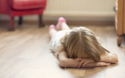 girl throwing a tantrum on floor