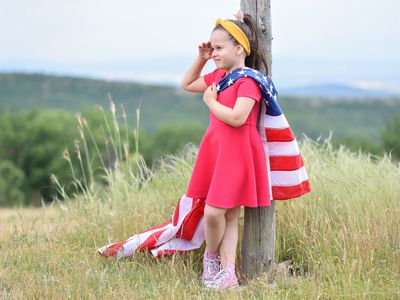 young girl holding an American flag